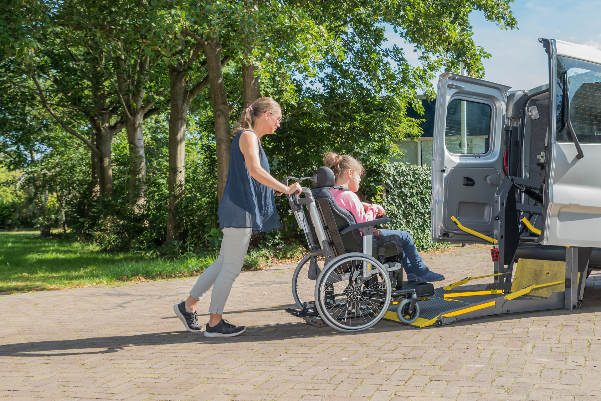 person in a wheelchair being helped by someone else